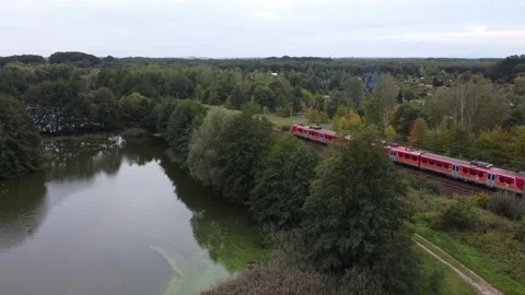 Train passing by next to lake Stock Footage 220632279