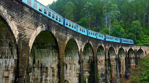 Train passing old Nine Arches Bridge. Famous travel destination in Sri Lanka Stock Footage 73351924