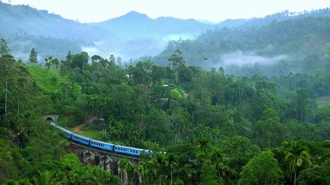 Train passing old Nine Arches Bridge. Famous travel destination in Sri Lanka Stock Footage 73351996