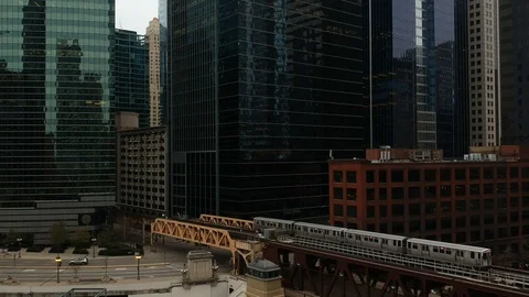 Train passing over bridge entering downtown Stock Footage 98720535