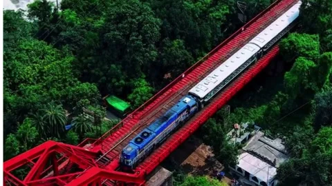 Train Passing Over Red Iron Rail Bridge 스톡 동영상 337715492