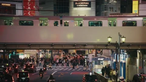 Train Passing Over Shibuya Crossing at Dusk, Tokyo Stock Footage 340865539