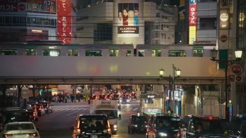 Train Passing Over Shibuya Crossing as Pedestrians Wait, Tokyo Stock Footage 340865841