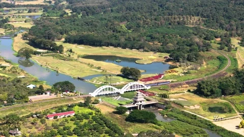 Train passing over Tha Chomphu White bridge in Thailand Stock Footage 331375419