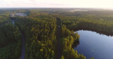 Train passing by a pond, Cinema 4k aerial view above railway tracks of a litt Stock Footage 78658230