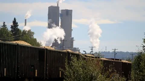 Train passing pulp mill Stock Footage 10748923
