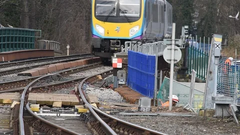 Train passing rail workers repairing rail bridge york uk Stock Footage 103263817