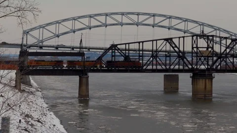Train Passing On A Railway Bridge Over An Icy Missouri River in the Winter Stock Footage 103346232