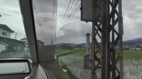 Train Passing Rice Fields and Villages Stock Footage 323914618