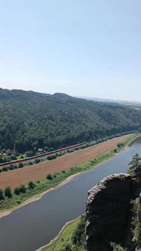 Train Passing River and Green Hills Stock Footage 341132834