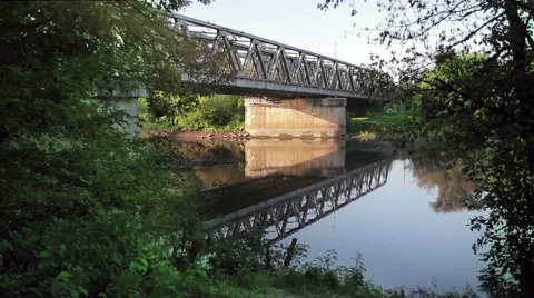 Train passing on the small bridge over the small river Stock Footage 68159236