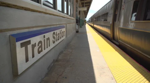 Train passing the station sign Stock Footage 65380246