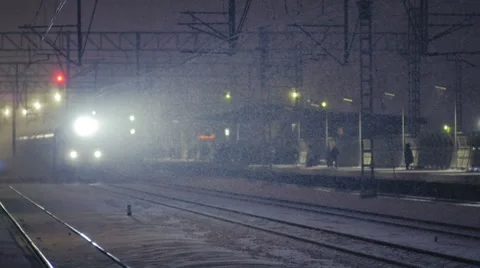 A train passing a station in snow (slow motion) Video stock 63793258