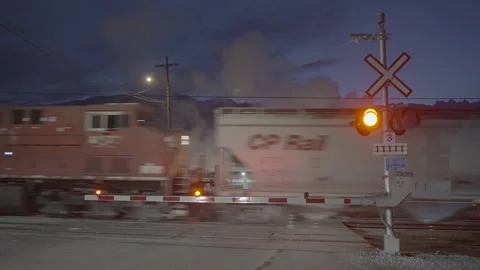 Train passing by street and gates opening up to traffic Stock Footage 225408837