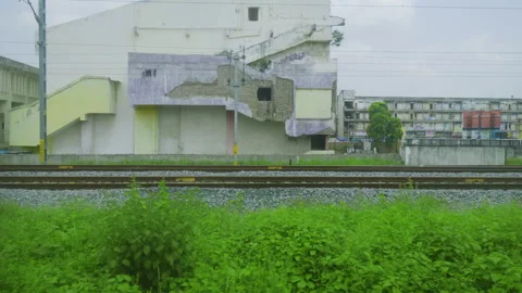Train Passing Subway Underpass and Buildings Near Mehsana Station Stock Footage 344070438