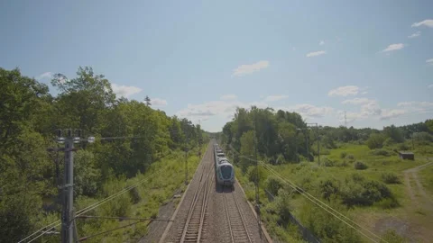 Train passing by in the summer on a clear sky sunny day Stock Footage 258172710