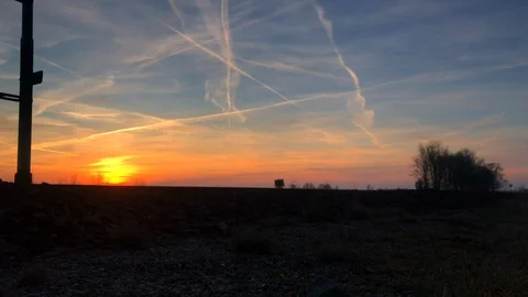 Train passing by with sunset and sky with airplanes condensation Stock Footage 103133065
