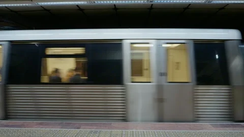 Train passing through busy subway station during urban travel hours Stock Footage 315226716