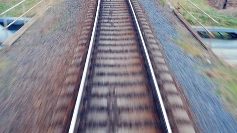 Train passing through countryside, moving railroad tracks Stock Footage 98720214