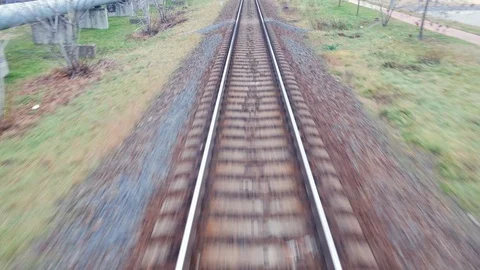 Train passing through countryside, moving railroad tracks Stock Footage 98720832
