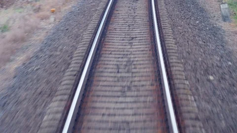 Train passing through countryside, moving railroad tracks Stock Footage 98722383