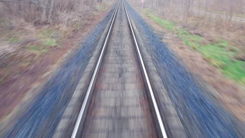 Train passing through countryside, moving railroad tracks Stock Footage 98722694