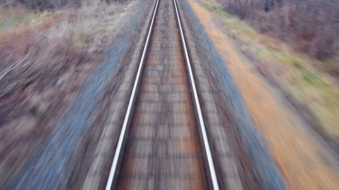 Train passing through countryside, moving railroad tracks Stock Footage 98722921
