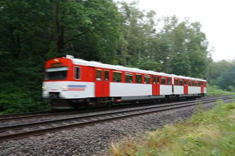 Train passing through forrest in North Germany Stock Photos