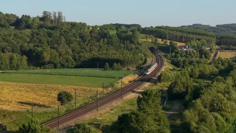 Train Passing Through Green Fields With Lush Vegetation In Summer - Static Shot Stock Footage 281645582