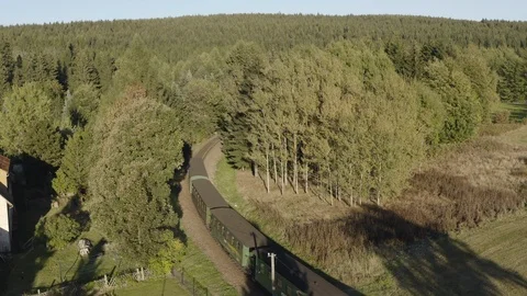 Train passing through lush landscape Stock Footage 116205921