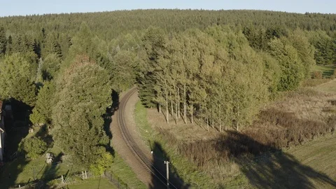 Train passing through lush landscape Stock Footage 116206117