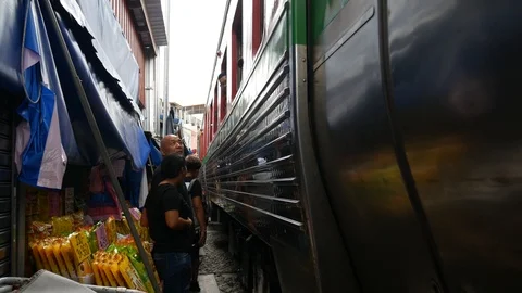 Train passing through the middle of the market, Thailand Stock Footage 114974686