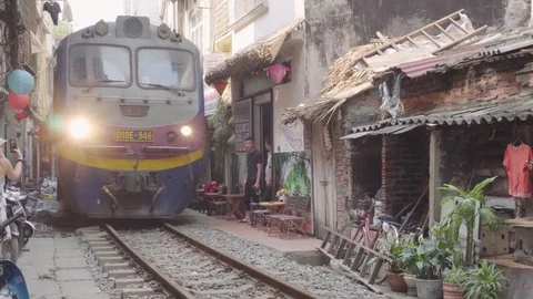 Train passing through narrow street of the Hanoi Old Quarter Stock Footage 108264322