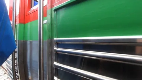 Train passing through the open air railway Maeklong markets in Thailand. Stock Footage 77717737