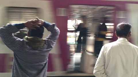 Train passing through platform Stock Footage 99910655