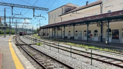 Train passing through Postojna railway station Stock Footage 339917718
