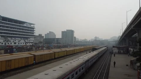 Train Passing Through Station with Platform and City in Dhaka Stock Footage 327374464