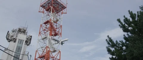 Train passing through train station on tracks, surrounded with poles, Tokyo Stock Footage 136126974