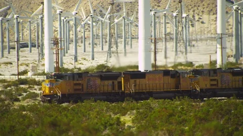 Train Passing Through a Wind Farm Stock Footage 75207874
