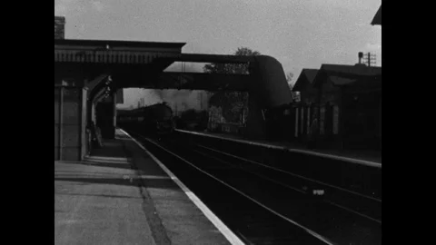 A train passing by a train station, adventure of coal, united kingdom, 1947 Stock Footage 131532683