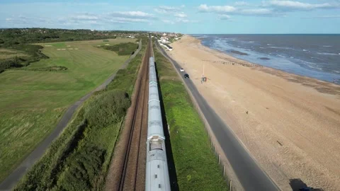 Train Passing Under Drone Shot, Pevensey Bay Beach and Rail Stock Footage 303282273