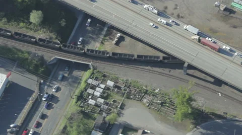 Train Passing Under Highway Traffic Bridge - Aerial Stock Footage 46157637