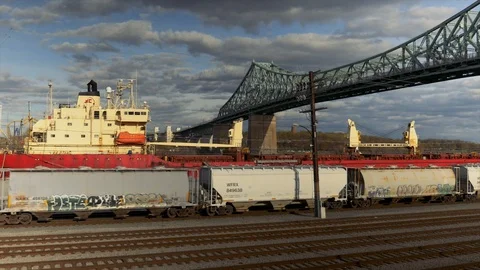 Train Passing under the Jacques Cartier Bridge in Port of Montreal Quebec Stock Footage 107851638