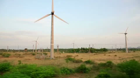 Train passing by working wind turbines Video stock 23330989