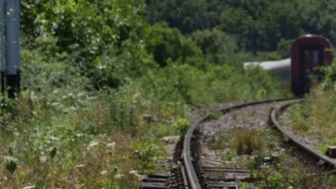 Train people that move away with speed seen in fog due to heat on railroad tr Stock Footage 71756737