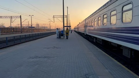 Train platform with freight train and passenger train Stock Footage 267405216