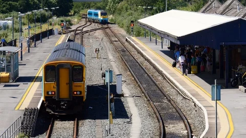 Train at platform, with train pulling on to patform Carmarthen Wales Stock Footage 93859433