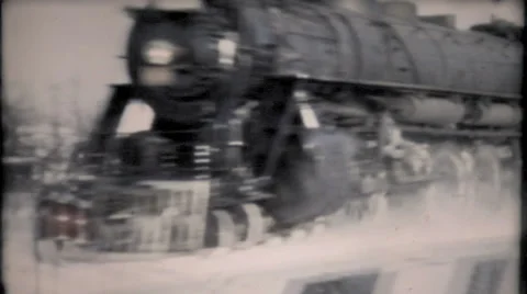 Train plows through the snow in small town 1950s vintage film home movie 856 Stock Footage 34580719