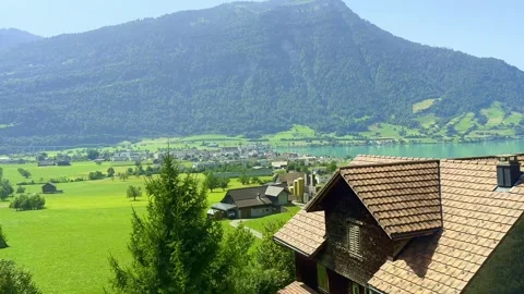 Train Point of View over Lake Zug and Mountain in a Sunny Summer Day Vídeo Stock 264576309