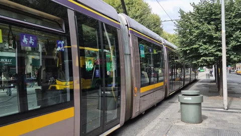 Train from the public transport passing by O'Connell Street Upper in the city Stock Footage 345098969